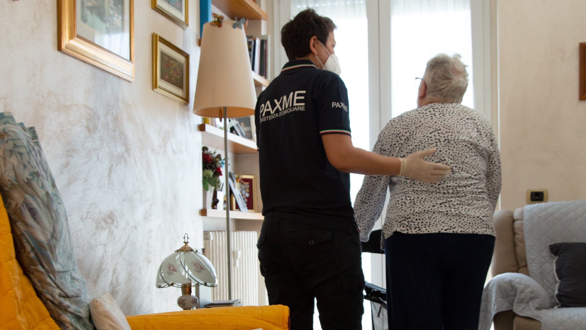 Dipendente Paxme che aiuta una persona anziana disabile